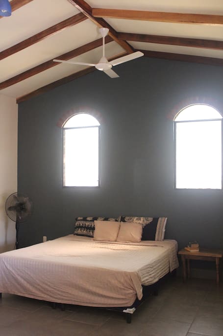 The master bedroom with king sized bed and attached bathroom.
