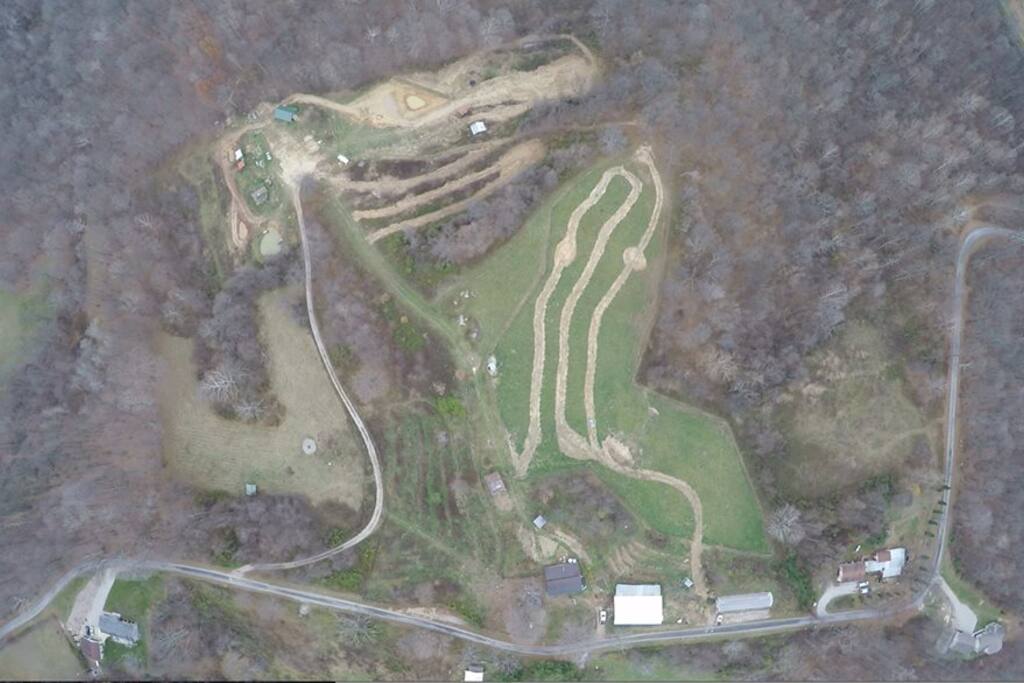 Aerial photo of the 17 acre farm, showing terraces, ponds, and trails.