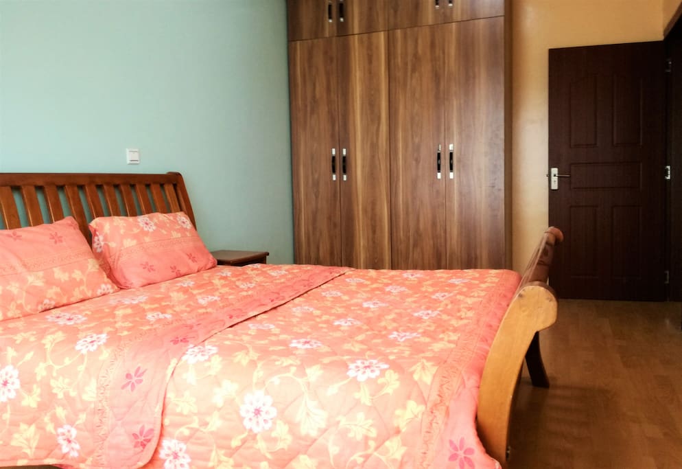 Room with queen bed and built in draws