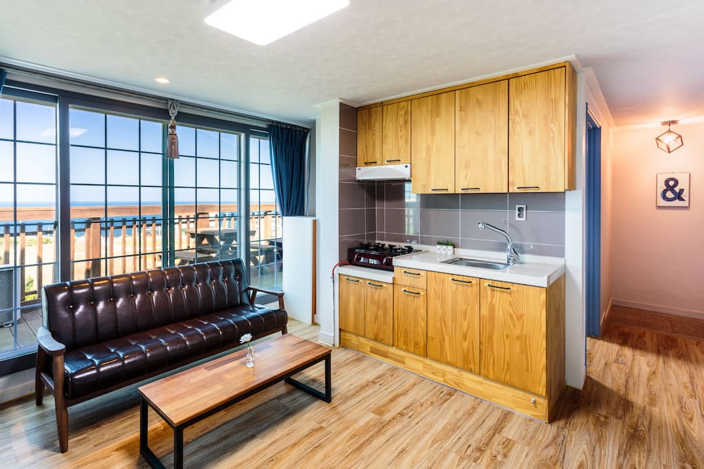 A living room with a kitchen.