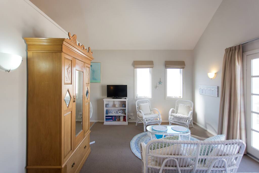 Television viewing from bed or cane wicker setting.