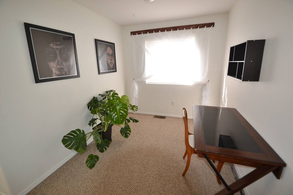 The Loft room is a well lit, open room set up for a business center. Access to wifi and electrical outlets are provided in the simple, yet elegant room.