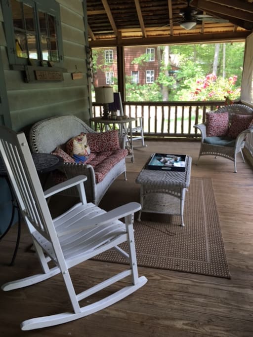 Porch living at its best with this new, screened in porch with comfy wicker and rockers!