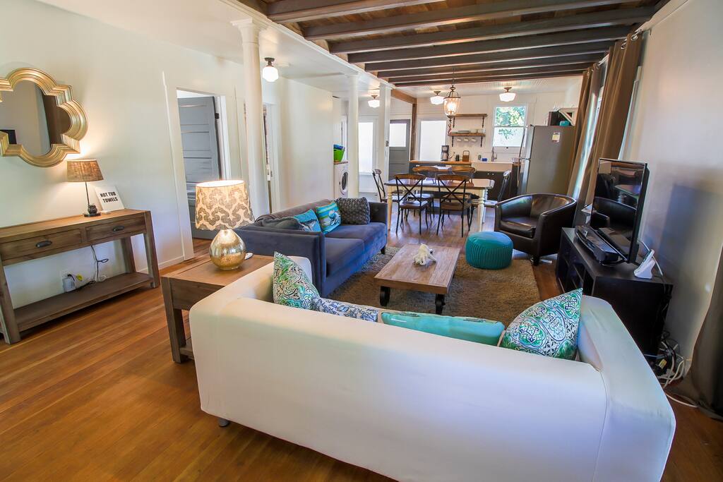 Hardwood floors and exposed beams run the length of the entire airy, open living area.