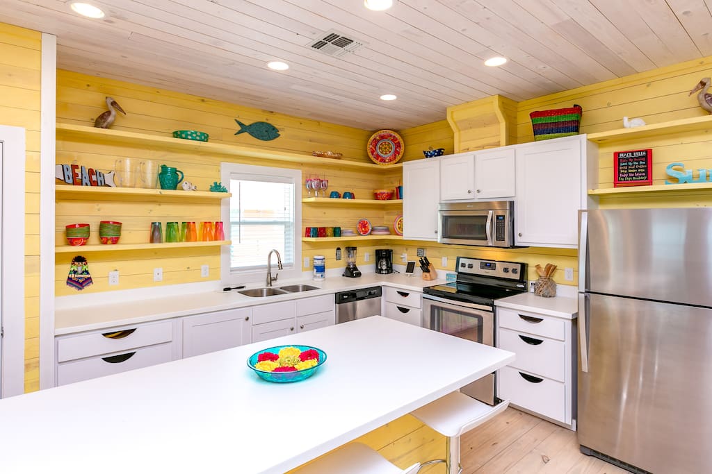Nautical kitchen with a center island and stainless steel appliances.