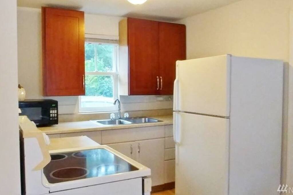 Full Kitchen with Fridge/Freezer, Microwave, Range/Oven, Cupboards, Double Sink, Keurig, as well as basic cooking and eating tools.