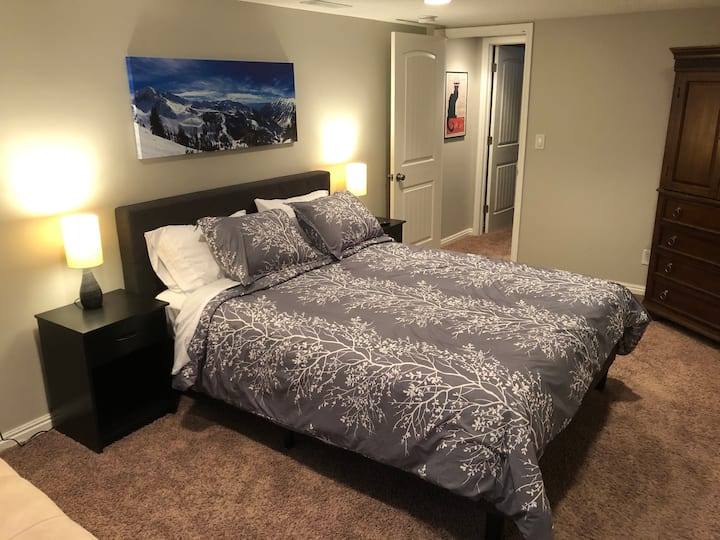 Downstairs master bedroom with queen bed, futon, 43" Roku TV, large walk in closet and direct access to master bath.