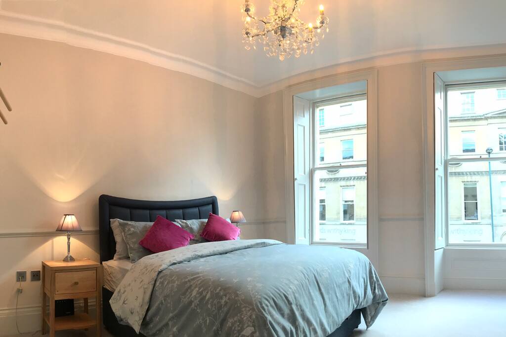 King Sized bed in stunning bedroom with crystal chandelier