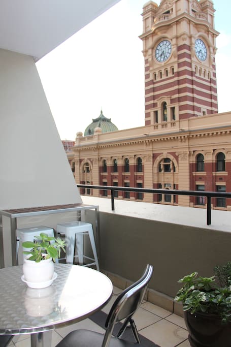 Balcony view of Flinders St Station clock tower.