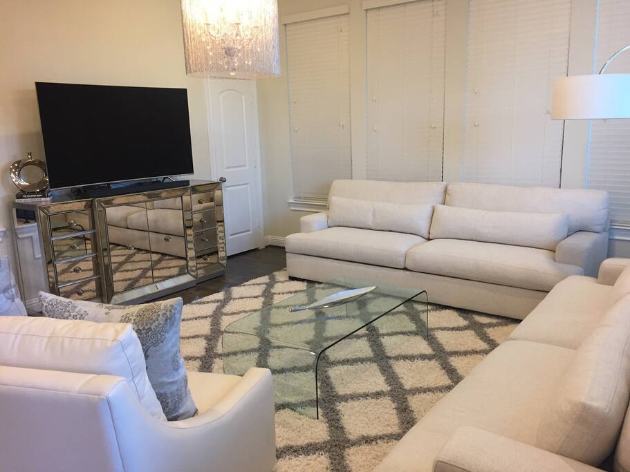 living room with 65' curved TV