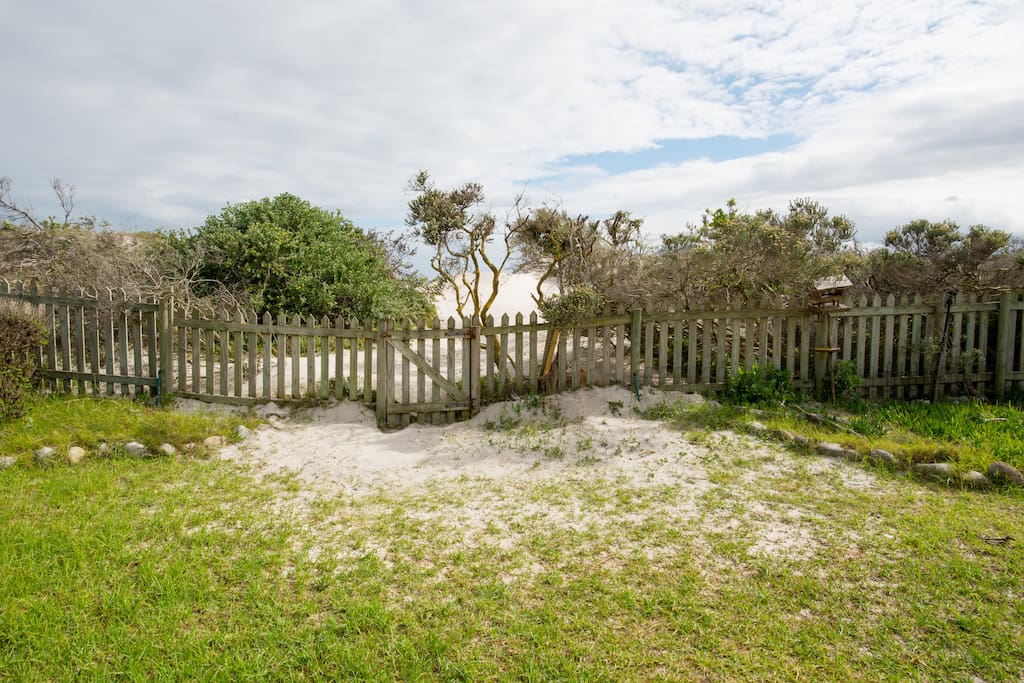 Garden gate opens onto the dunes