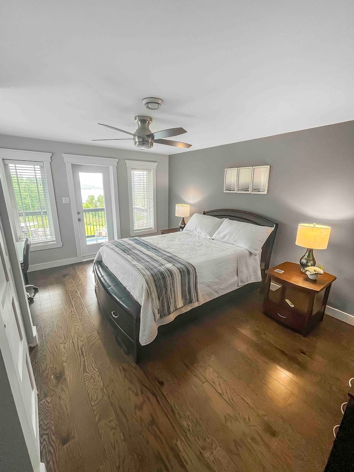 Master bedroom, featuring a queen bed and an attached balcony.