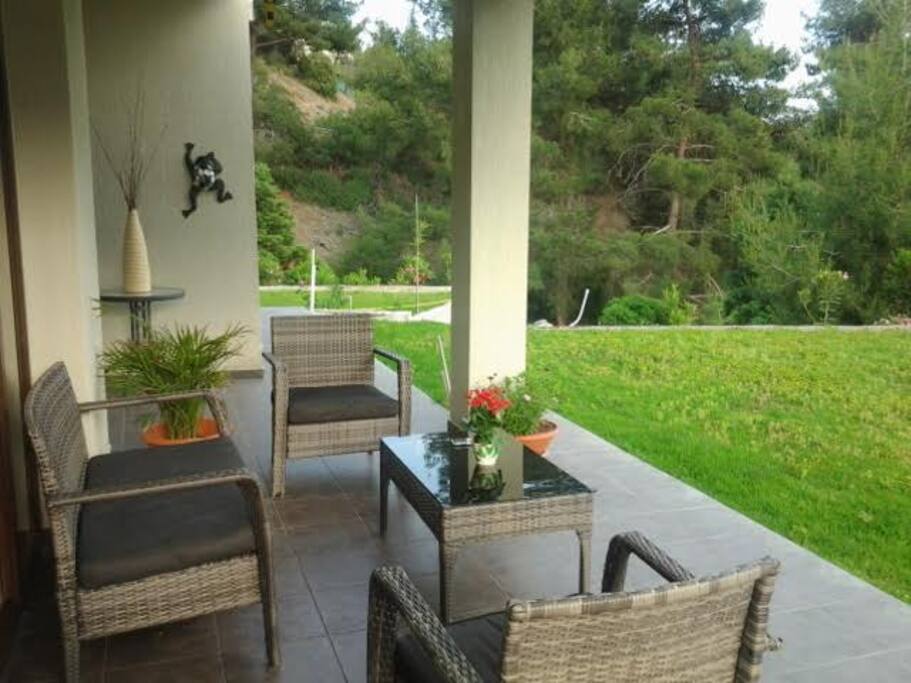 covered patio next to lounge and pool
