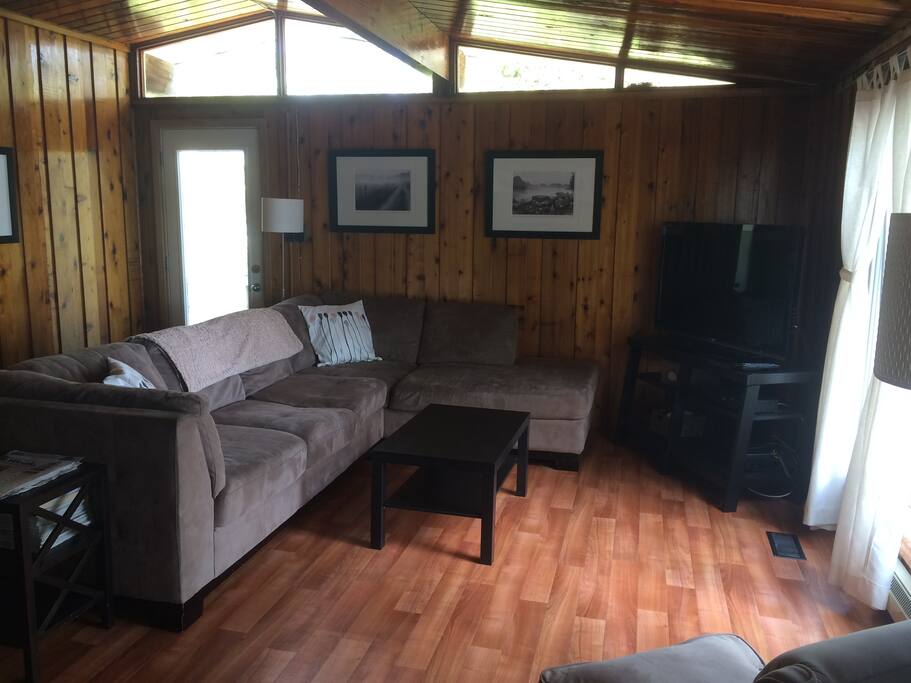 Cottage main floor with two separate entrances, vaulted ceilings and bay window view of waterfront.
