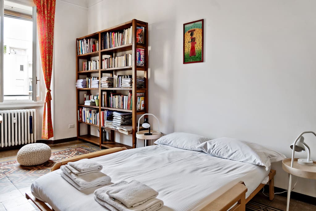 The Bedroom - The comfortable double bed with soft bed-linen and towels & The Bookcase