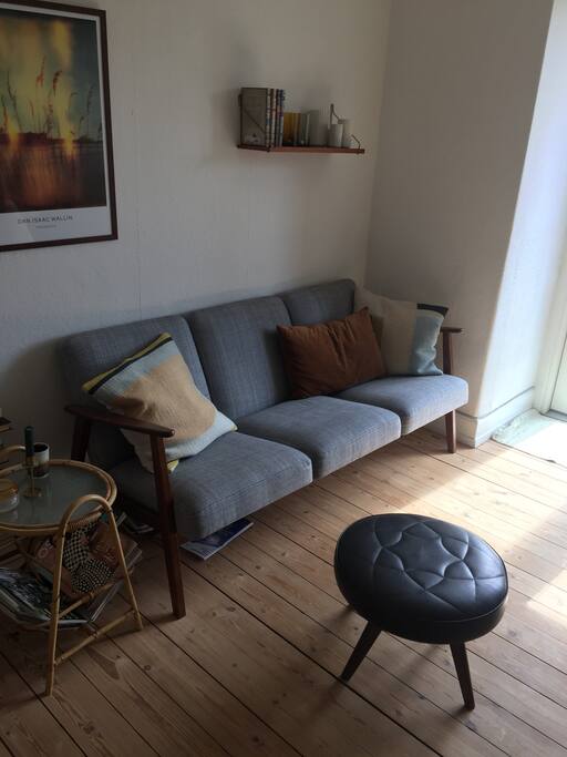 Sofa in the living room, next to the balcony door.