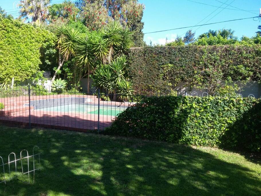 Outside geared for summer. Pool close to braai area