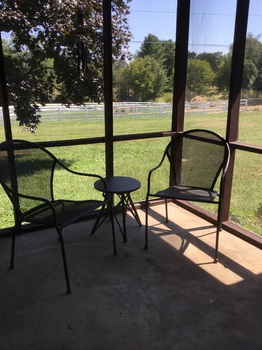 Screened in porch with views of the goats.