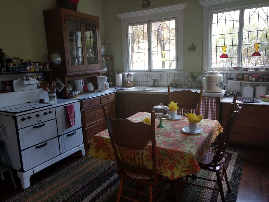Fully equipped kitchen with French door refrigerator and wall oven. On chilly mornings enjoy coffee or tea by the cast iron gas heater and warm your feet on the heated rug under the kitchen table.