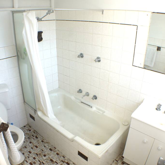 Light & airy ensuite bathroom with shower and bathtub