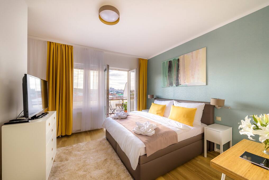 Master bedroom filled with the daylight. The skilful combination of colours brings the sense of calm and joy together.