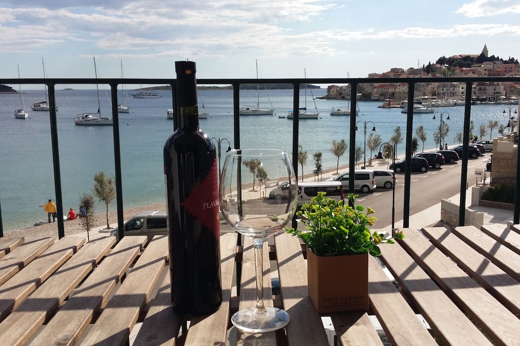 Enjoy a glass of wine on the terrace overlooking the beach and the Old town