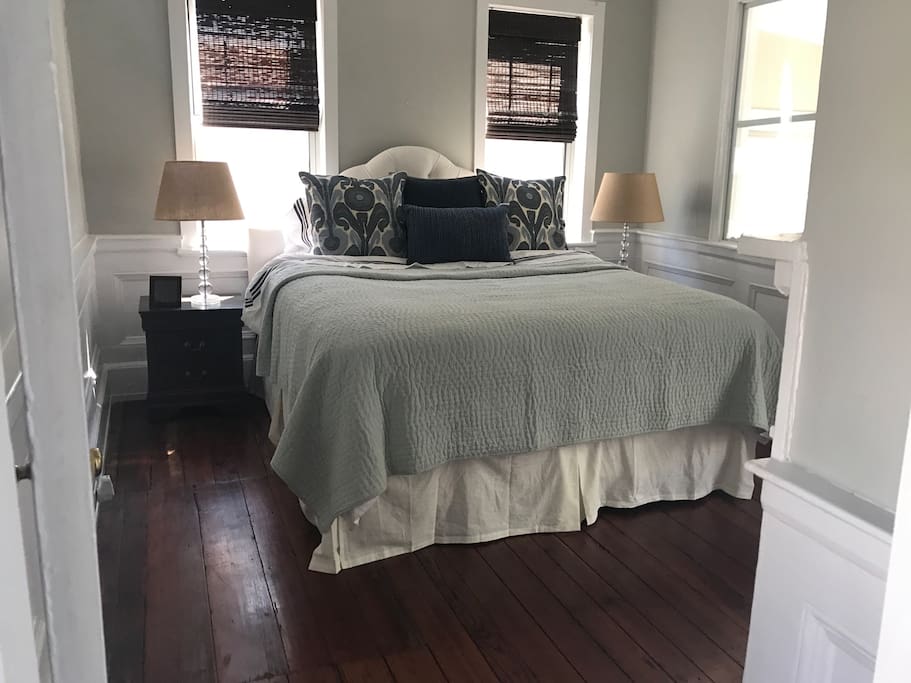 Master bedroom with king size bed and closet.