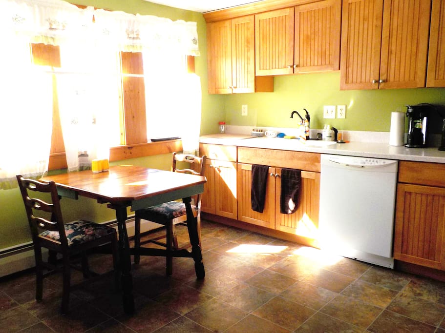 Large, sunny, eat-in kitchen with full-sized appliances, including dishwasher, single serve coffee maker and garbage disposal.