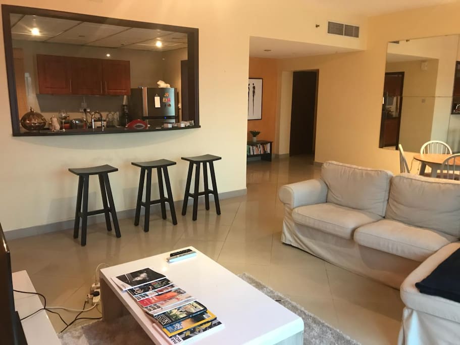 Spacious living room wt TV, bar area, fully-equipped kitchen, laundry room & storage room