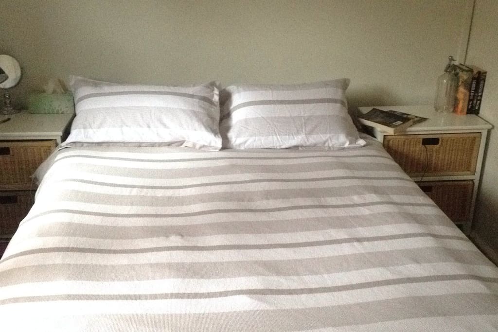 Cosy queen bedroom with blackout curtains