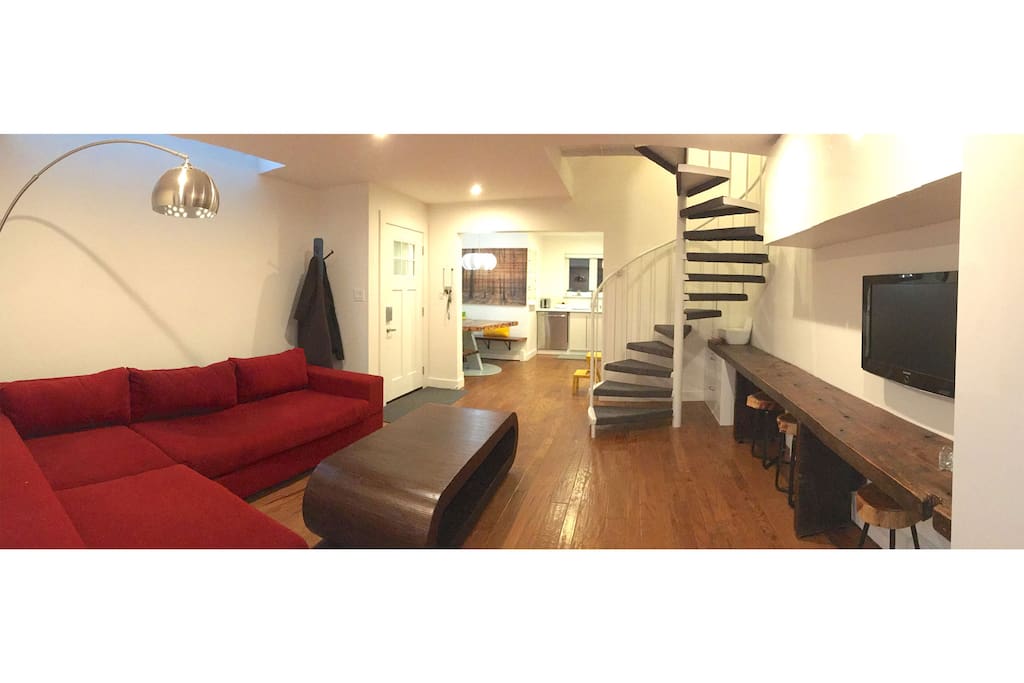 Large "L" couch, great lighting, spiral staircase leading to bedroom, bathrooms and rooftop deck