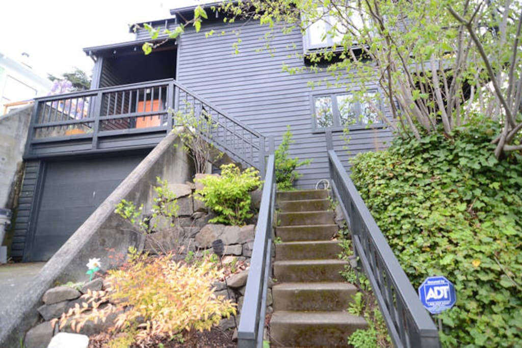 Front of the house, up a flight of stairs from the street.