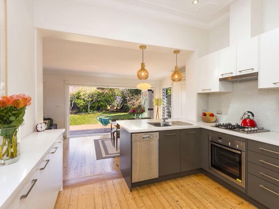Brand new designer kitchen with gas cooktop, oven, microwave and dishwasher