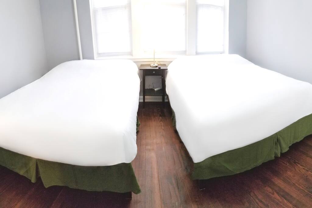 Sun-drenched master bedroom with 2 HUGE Queen size beds featuring some of the most comfortable gel memory foam mattresses in the industry for a good night's sleep