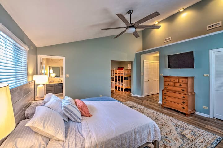An enormous master bedroom with a king bed and an attached bunk room