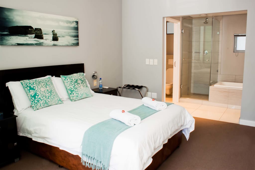 Bedroom with Double size bed. Open plan to bathroom with Shower, toilet and bath.