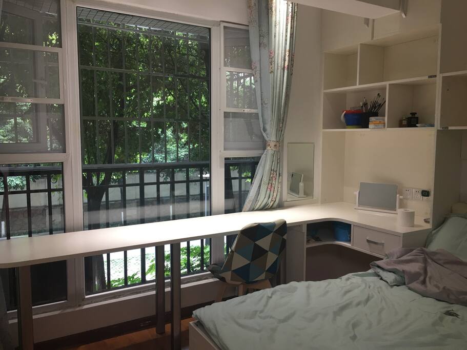 Bedroom with nice green garden out side the windows.