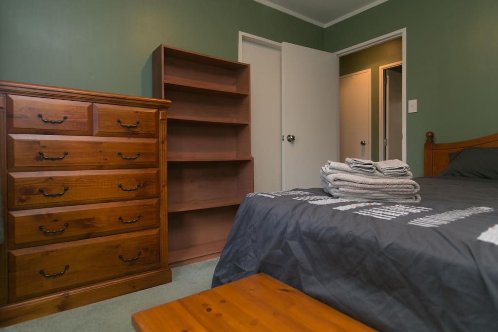 Queen bedroom with drawers and closet space