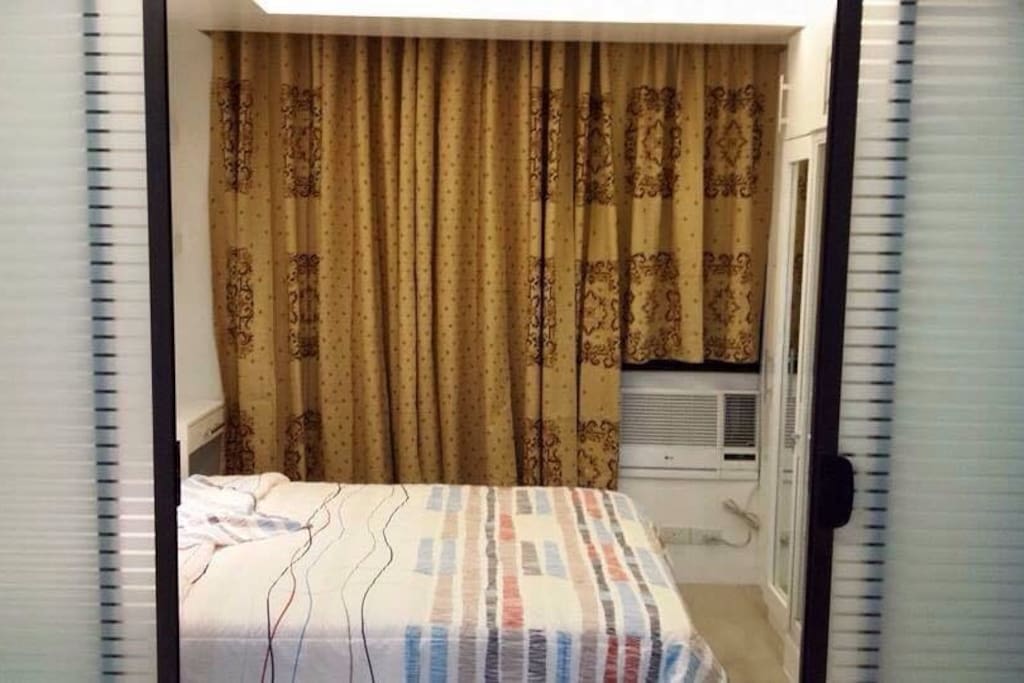 The division between the living room and the bedroom.