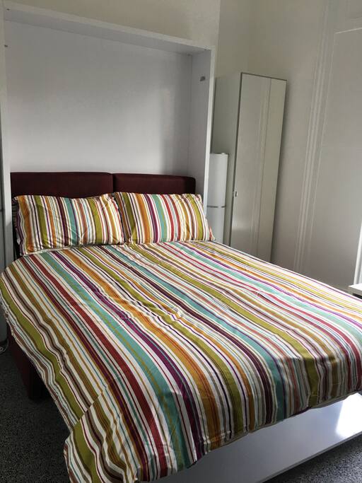 Double bed shown folded down over sofa