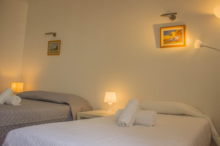 Private room with a double bed, two single and dining table
Private room with a doublebed, two singles and dining table