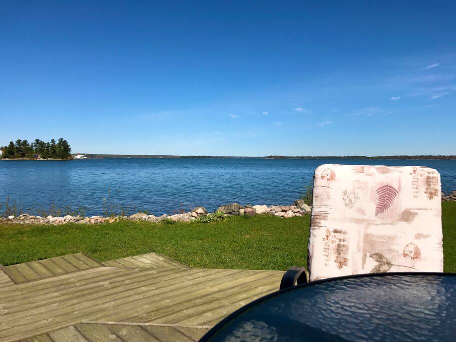 View to the left from the back deck. Outdoor table and 4 chairs included. Fire pit is located here. Wood can be purchased in town. Marshmallow roasting forks are included.