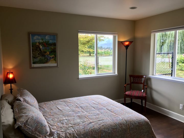 Bedroom 1 with vineyard and pond views. 