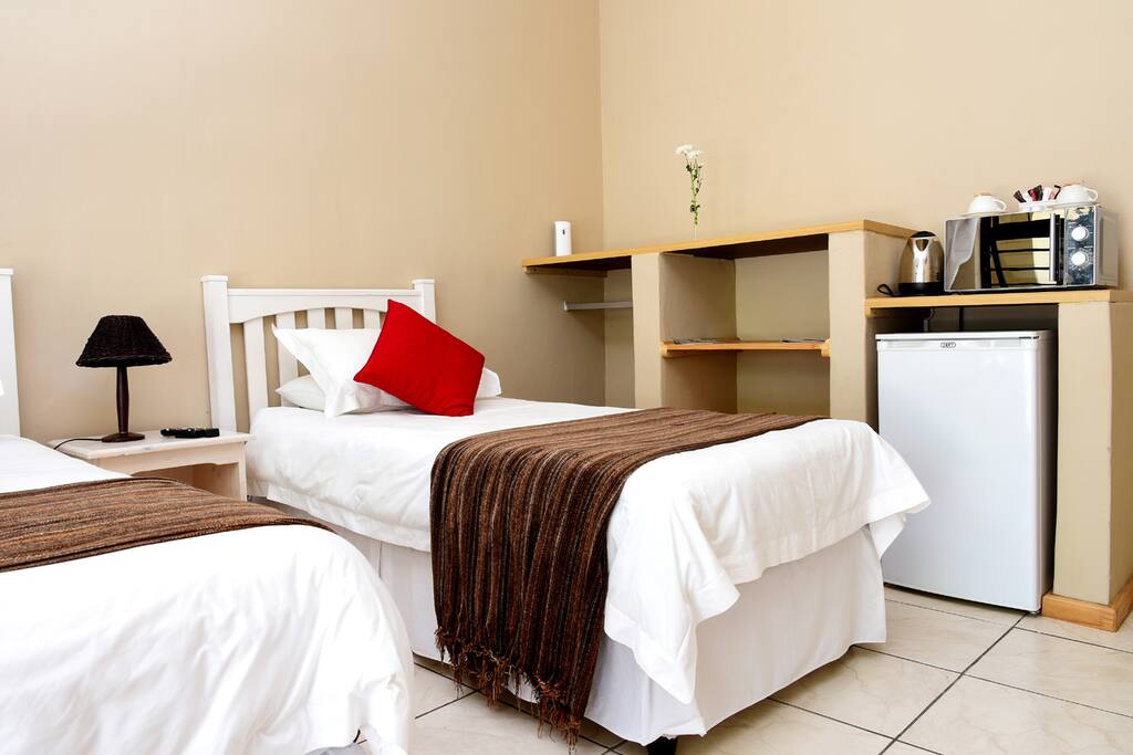 Room with fridge, microwave, crockery and kettle