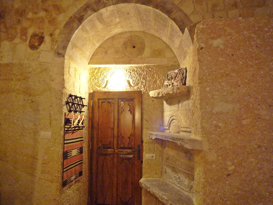 Roman suite cave bedroom, traditional clothes hanging space, door to bathroom.