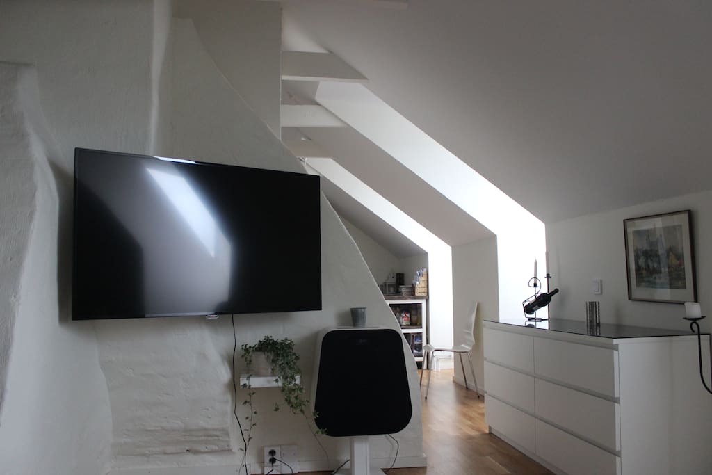 View from sofa. The flat has a "55 wall-mounted TV and a rather powerful sound-system if you wish to stay in for a movie night.
