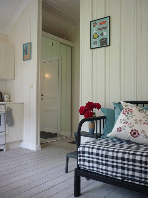 The entrance to the room has a large wardrobe with sliding mirror doors. High ceiling.