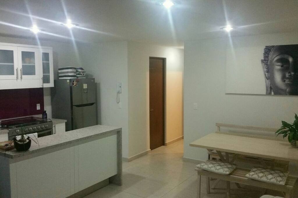 Dinner table and open space kitchen
