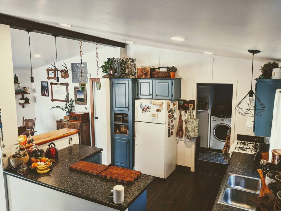 Newly remodeled kitchen. Open counter space, custom juniper bar top, fully stocked with all appliances (except no microwave), dishwasher.