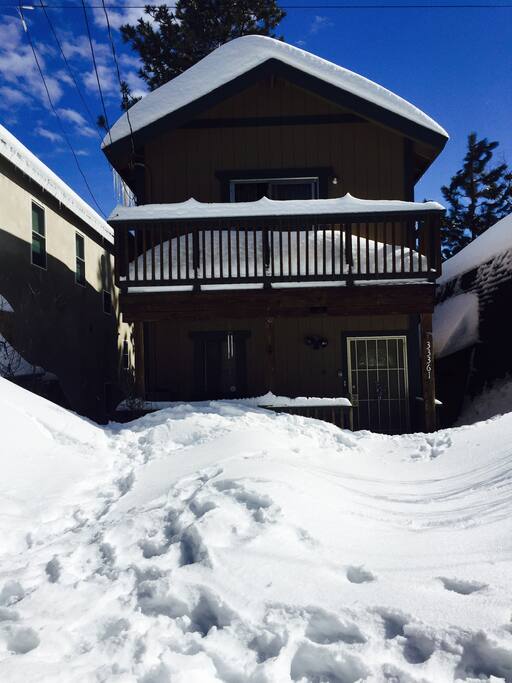 Front of the cabin with snow.